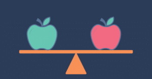 red and green apples on a balancing apparatus